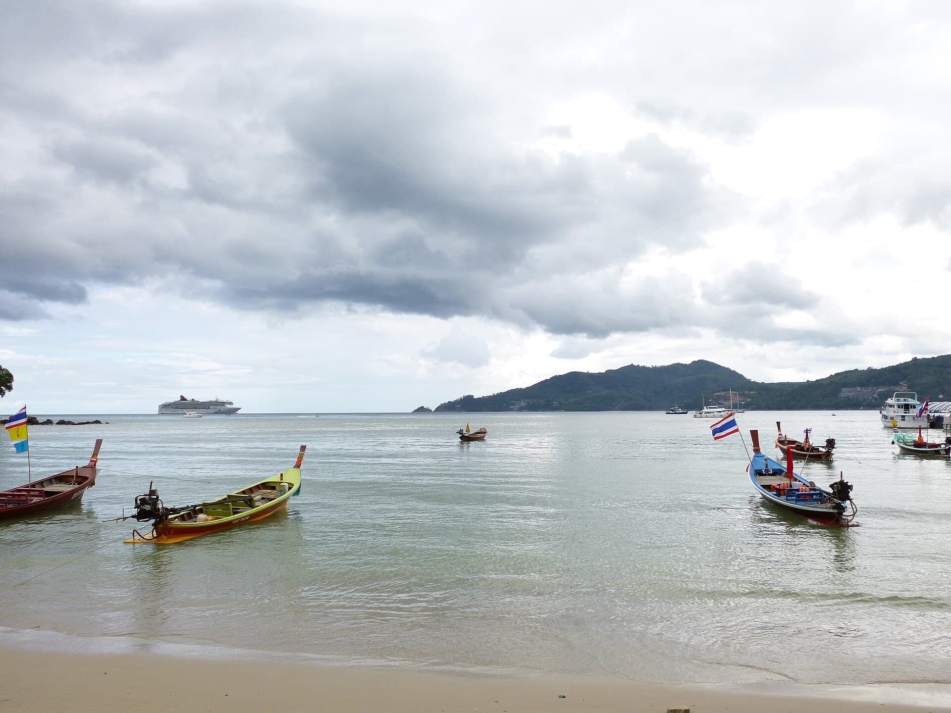Longtail boats in the shallows at Patong Beach