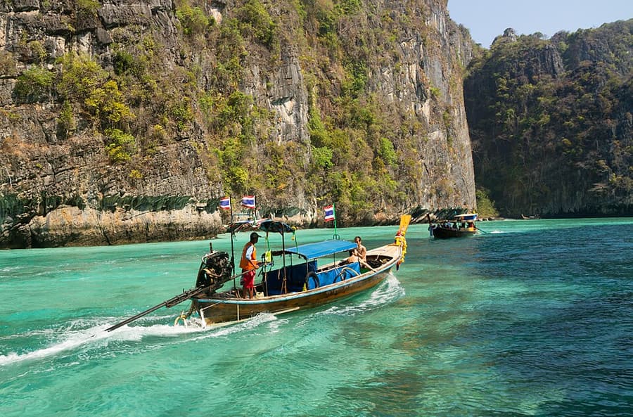 A longtail boat beneath the cliffs of Koh Phi Phi Leh